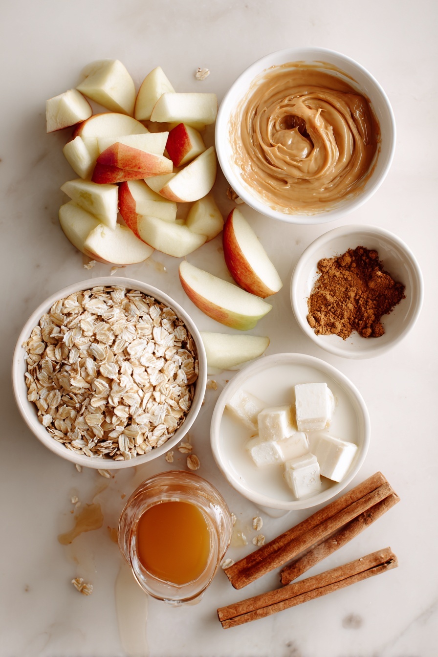 Flat lay of rolled oats in a small pile, whole peeled honeycrisp apples chopped into neat pieces, a creamy swirl of almond butter, solid chunks of coconut oil, a small heap of ground cinnamon, a drizzle of rich maple syrup flowing gently, and a splash of pale almond milk, all beautifully arranged in natural, soft lighting, placed on a white marble surface, photo taken with an iphone --ar 2:3 --v 7