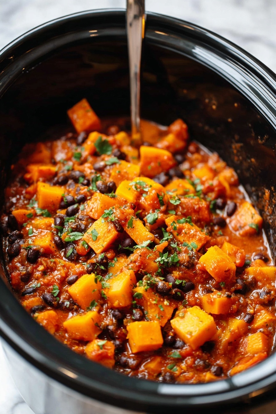 The image shows a close-up of a black slow cooker filled with a chunky stew. The stew has bright orange cubes of sweet potatoes mixed with dark black beans, soft brown lentils, and small bits of green herbs sprinkled on top. Steam rises from the stew, showing it is hot and fresh. A metal ladle lifts a scoop of the stew, displaying the mix of orange, black, and brown colors with bits of sauce holding the ingredients together. The background is a white marbled texture. Photo taken with an iphone --ar 2:3 --v 7