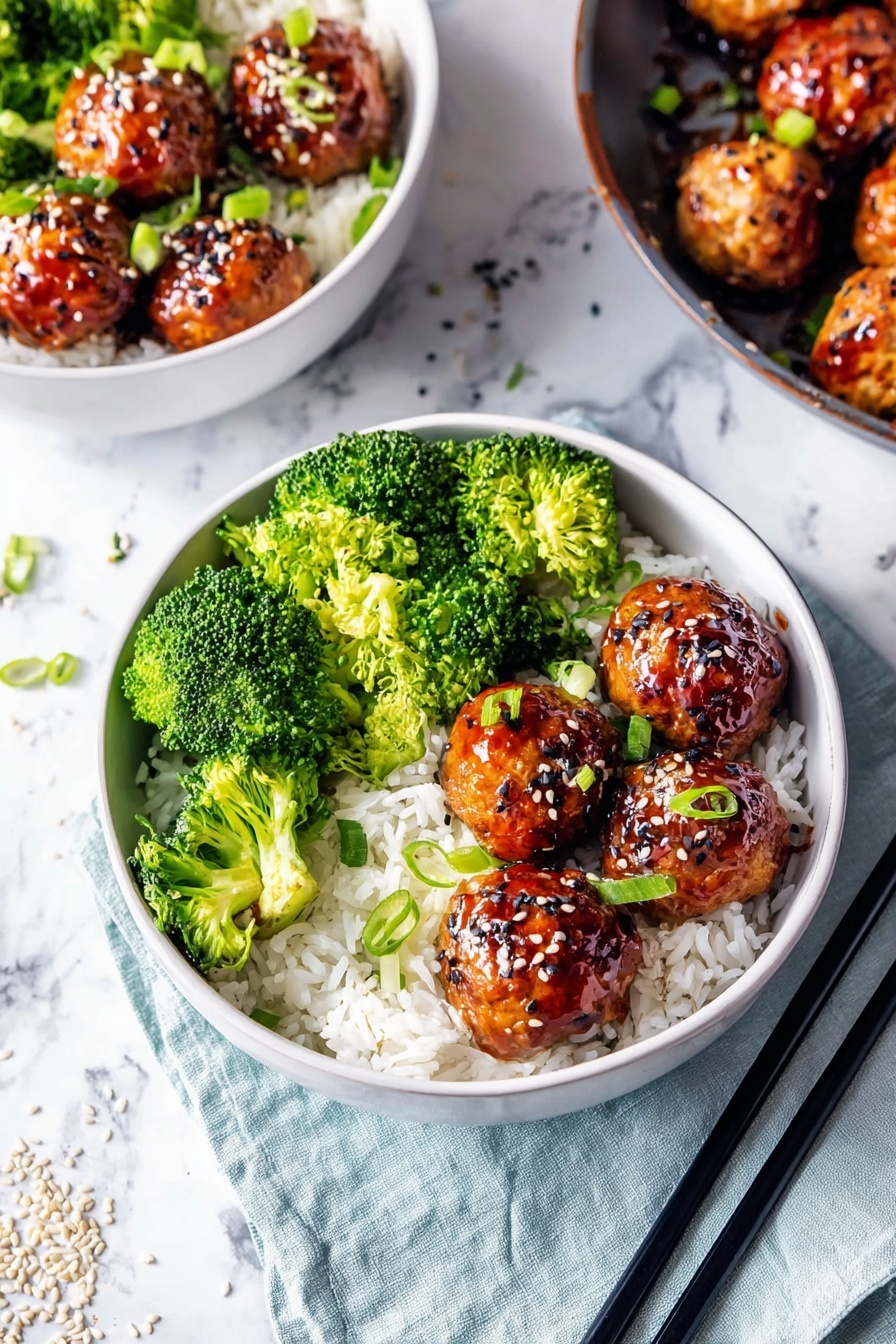 The image shows a white bowl filled with a base layer of white rice at the bottom. On one side of the bowl, there is a generous layer of bright green broccoli florets, which are fresh and textured. On the other side, there are six shiny, brown glazed meatballs stacked in a small pile, sprinkled with white and black sesame seeds and small green onion slices. Two black chopsticks rest beside the bowl on a light blue cloth on top of a white marbled surface. In the background, there is part of another similar bowl and a pan with more meatballs visible. Some sesame seeds are scattered around on the cloth and marbled surface. Photo taken with an iphone --ar 2:3 --v 7