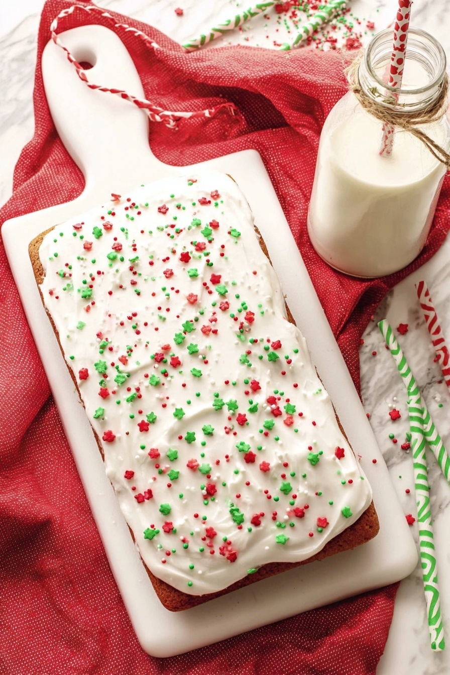 A rectangular cake lies on a white cutting board with a handle on the top left side, covered with smooth white frosting. The frosting is sprinkled evenly with small red, green, and white candy sprinkles in various shapes, adding bright color across the cake surface. The cake edges peek out slightly underneath the frosting, showing a brown color. A red cloth is underneath the board on a white marbled surface, adding warmth to the scene. Near the cake, there is a glass bottle filled with milk tied with a simple string, and two paper straws, one with green and white zigzag stripes and the other with red and white stripes, lie on the marble surface. Photo taken with an iphone --ar 2:3 --v 7