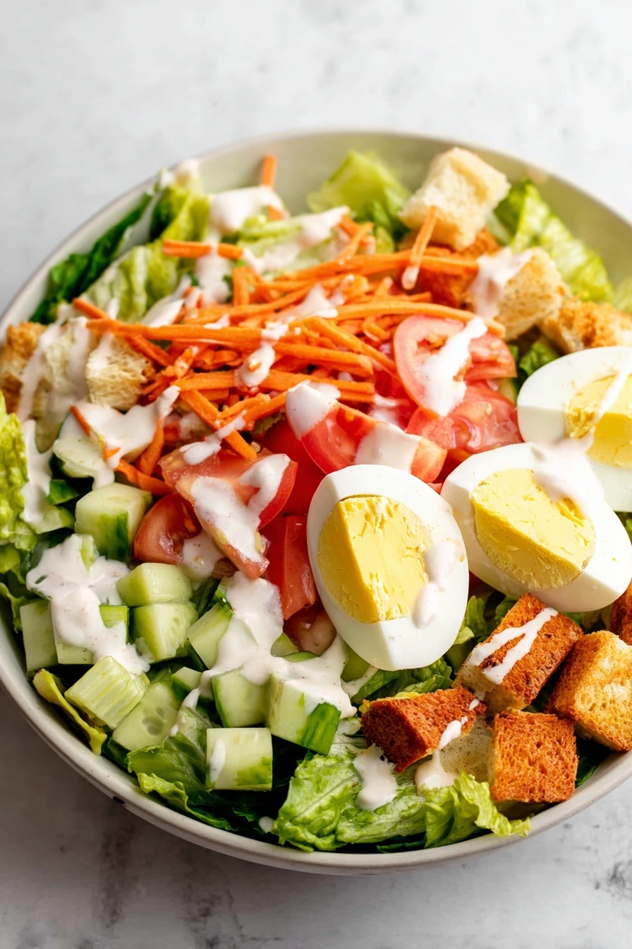 A large white bowl holds a fresh salad with several layers, starting with bright green lettuce leaves at the base. On top of that, there are scattered pieces of chopped cucumber with a light green color and chunks of red tomato. Thin orange shredded carrot strands are sprinkled over the vegetables. There are also slices of hard-boiled egg with white edges and yellow yolks placed on one side. Small golden-brown croutons are scattered across the salad, and a white creamy dressing is drizzled all over the top. The bowl is set on a white marbled texture surface. photo taken with an iphone --ar 2:3 --v 7